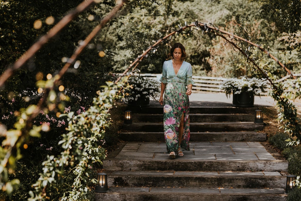 Wedding ceremony beneath a flowering garden archway