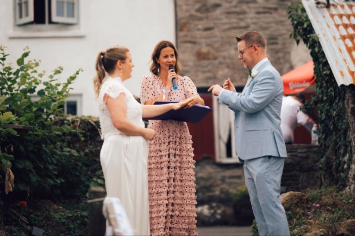 Wedding celebrant speaking during an outdoor ceremony